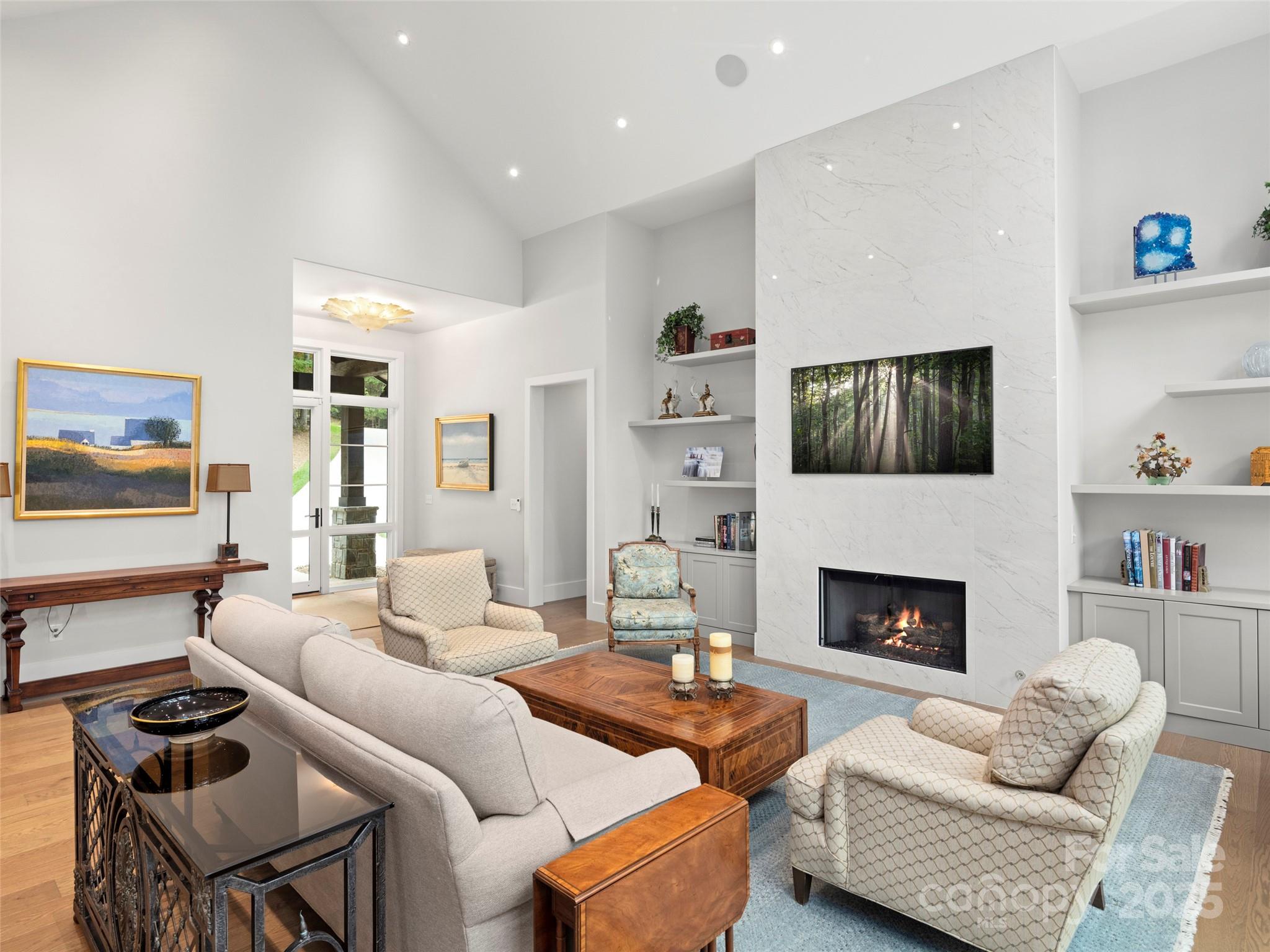 1565 Country View Way Arden, NC 28704 - Photo 6 of 31 a living room with furniture flat screen tv and a fireplace