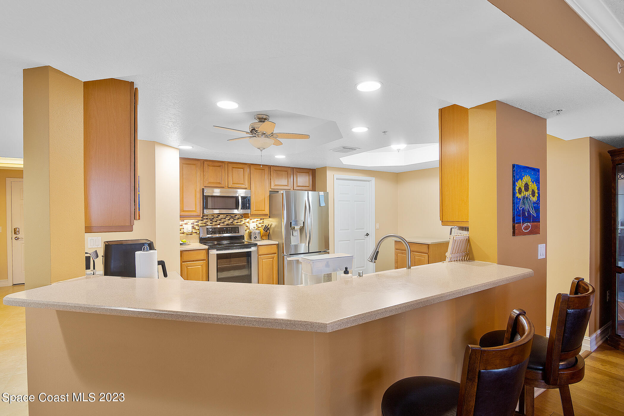 134 Starboard Lane, Unit 306 Merritt Island, FL 32953 - Photo 14 of 42 a kitchen with counter top space cabinets and stainless steel appliances