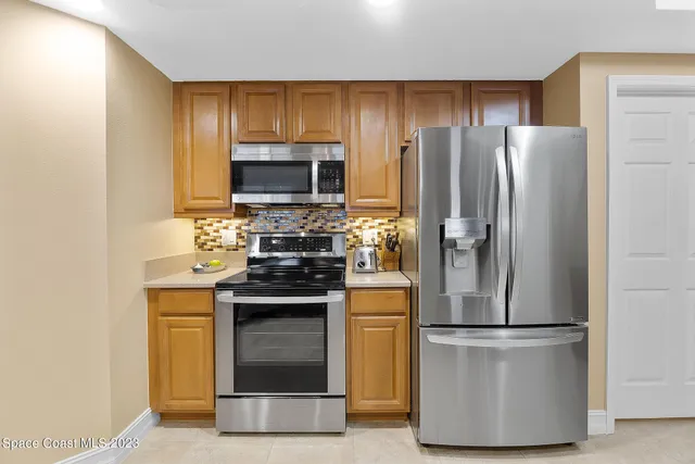 a kitchen with a refrigerator sink and stainless steel appliances