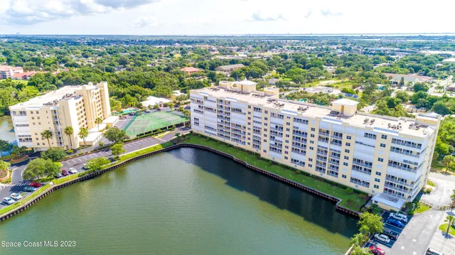 a living room with furniture a bookshelf and a window
