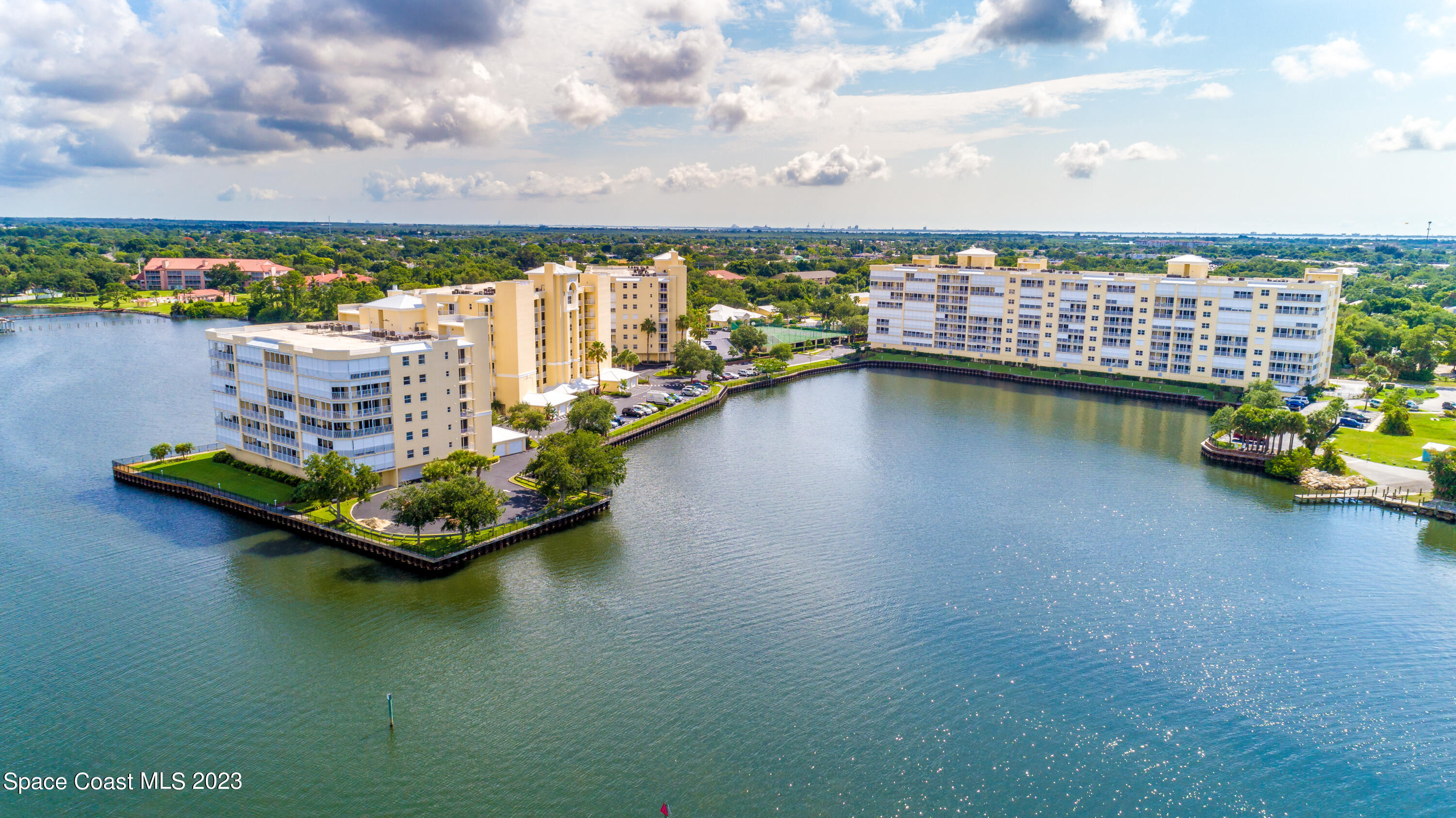 134 Starboard Lane, Unit 306 Merritt Island, FL 32953 - Photo 40 of 42 a view of a lake with a large building