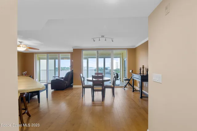a living room with furniture a flat screen tv and a large window