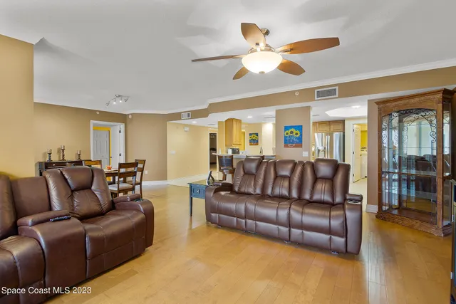 a living room with furniture a large window and a flat screen tv