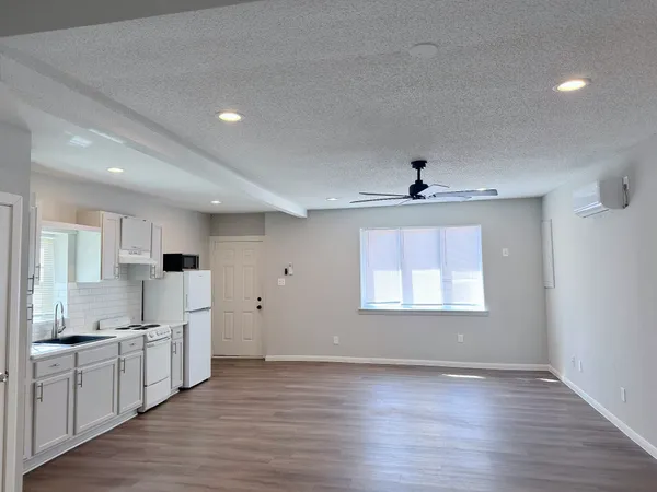 a view of a kitchen with a sink and wooden floor