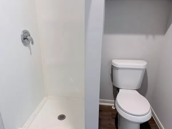 a bathroom with a toilet and a shower