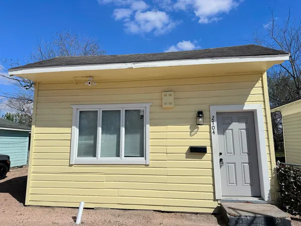 a view of a house with a door and wooden floor