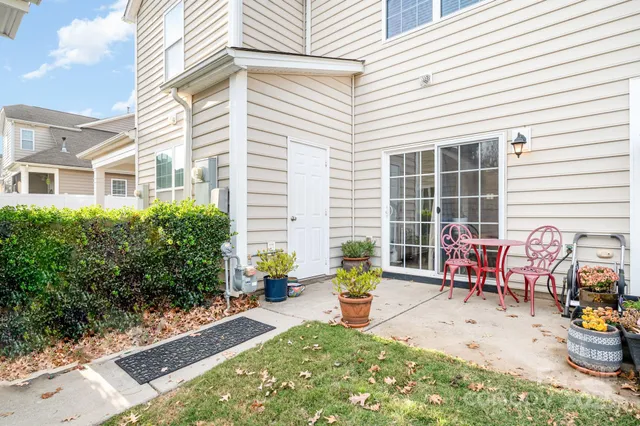 a view of a patio with chairs and plants