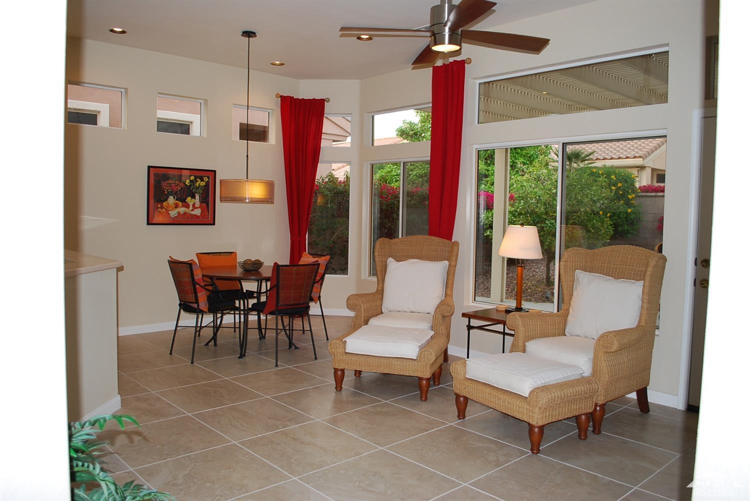 78082 Hunter Point Road Palm Desert, CA 92211 - Photo 11 of 38 a living room with furniture a flat screen tv and a large window