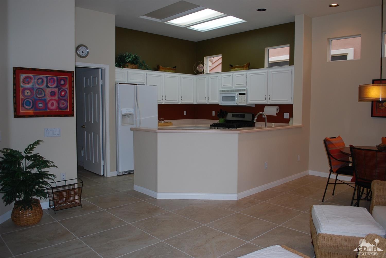 78082 Hunter Point Road Palm Desert, CA 92211 - Photo 12 of 38 a view of kitchen with furniture and a potted plant