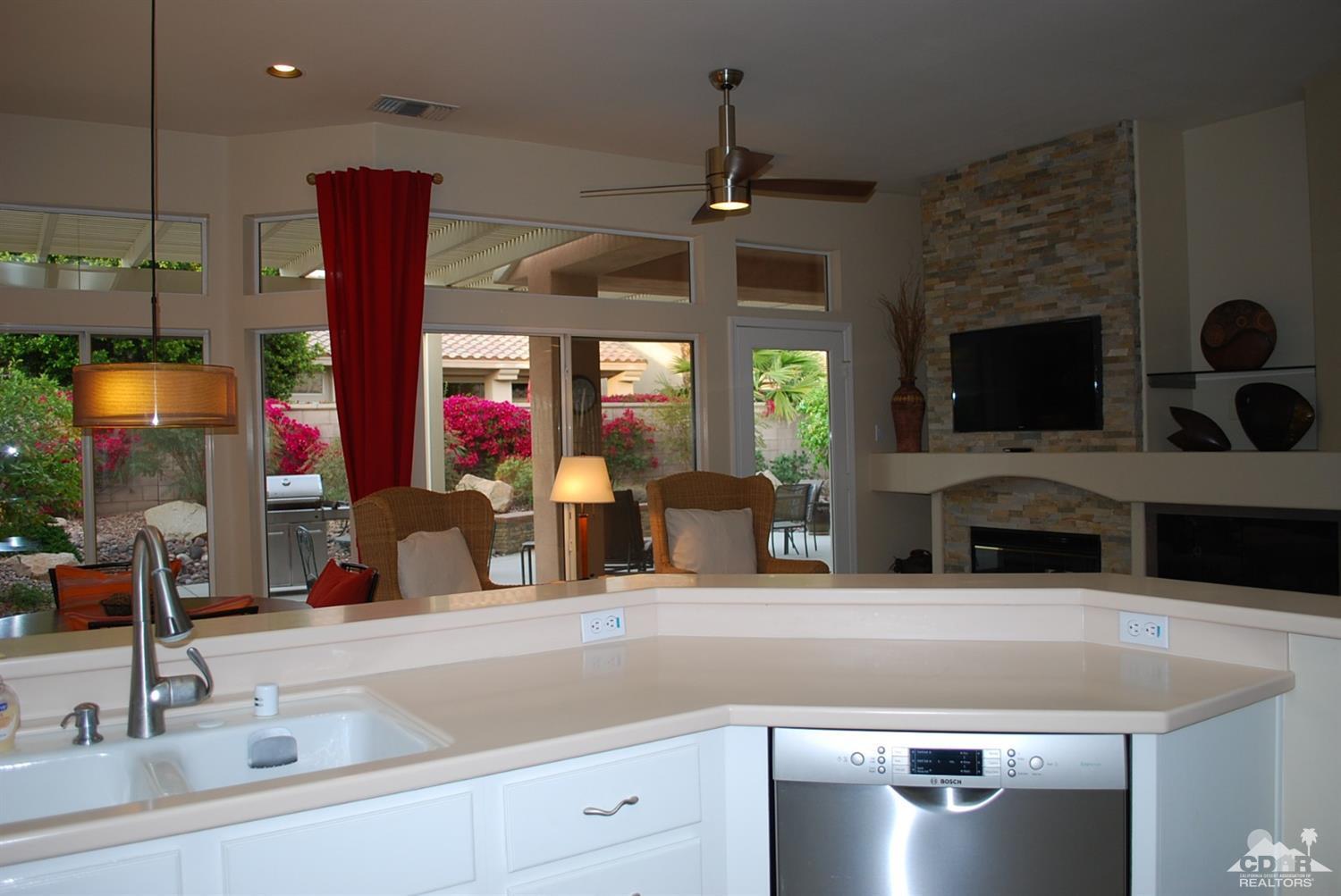 78082 Hunter Point Road Palm Desert, CA 92211 - Photo 13 of 38 a kitchen with stainless steel appliances kitchen island granite countertop a sink and a microwave