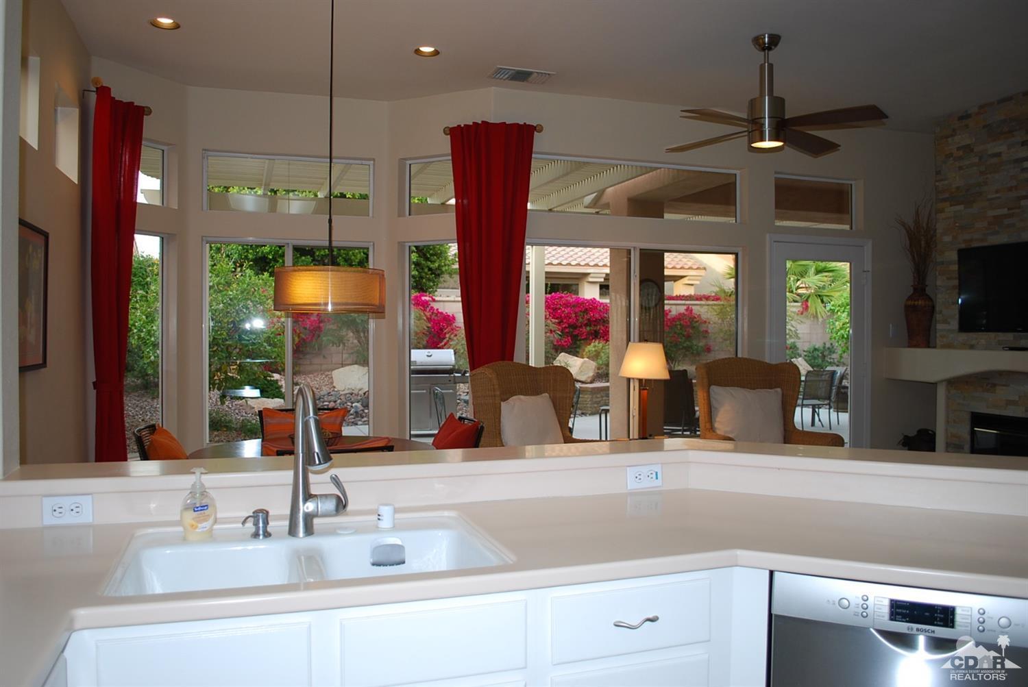 78082 Hunter Point Road Palm Desert, CA 92211 - Photo 14 of 38 a kitchen with a sink and a large mirror