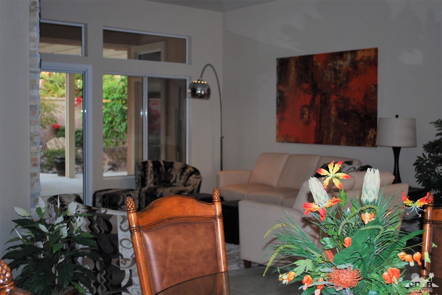 78082 Hunter Point Road Palm Desert, CA 92211 - Photo 3 of 38 a living room filled with furniture and a potted plant