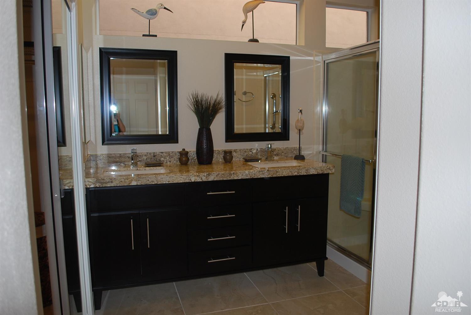 78082 Hunter Point Road Palm Desert, CA 92211 - Photo 21 of 38 a bathroom with a granite countertop sink and a mirror