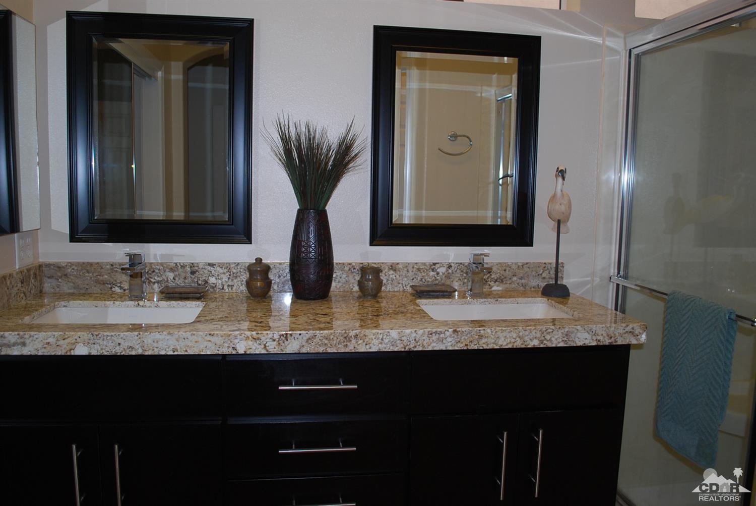 78082 Hunter Point Road Palm Desert, CA 92211 - Photo 22 of 38 a bathroom with double vanity sinks and a mirror