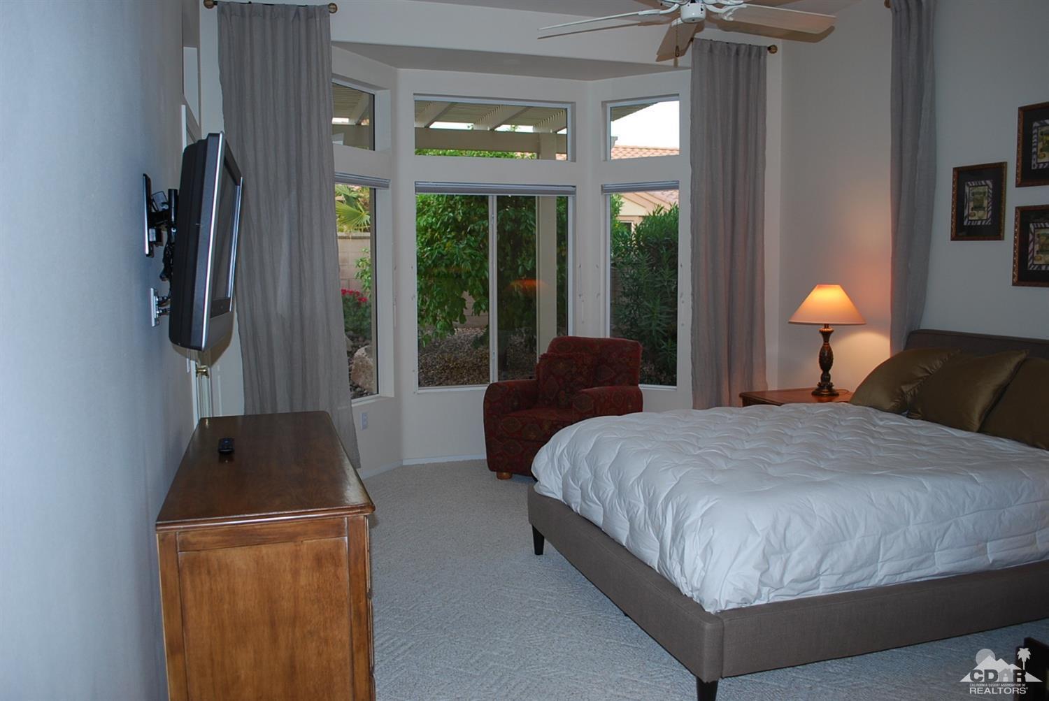 78082 Hunter Point Road Palm Desert, CA 92211 - Photo 23 of 38 a bedroom with a bed and large window