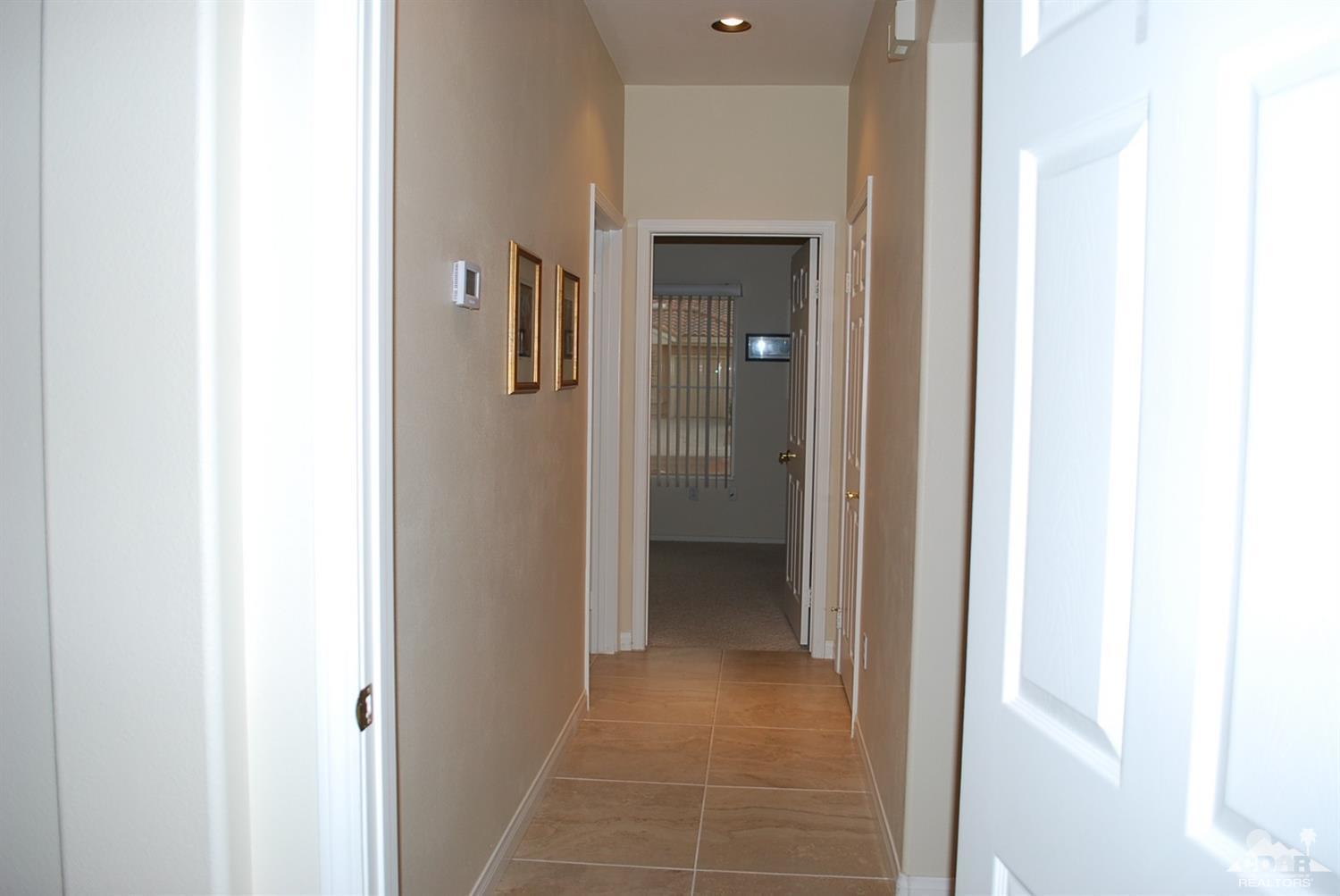 78082 Hunter Point Road Palm Desert, CA 92211 - Photo 25 of 38 a view of a hallway with an entryway door