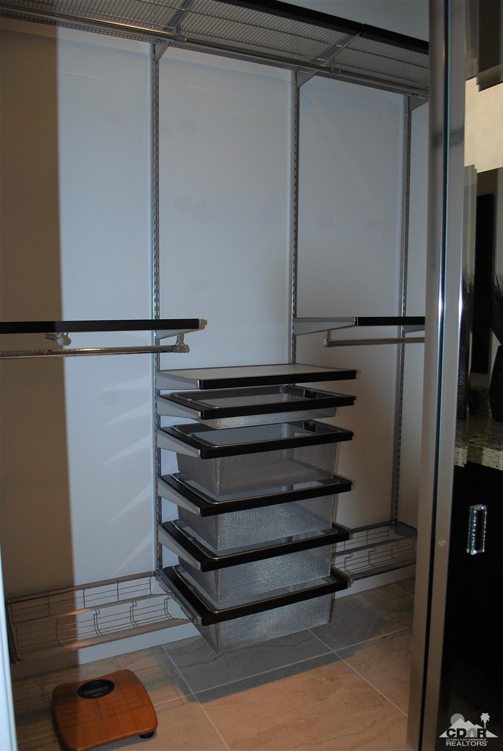 78082 Hunter Point Road Palm Desert, CA 92211 - Photo 27 of 38 a view of walk in closet with empty racks