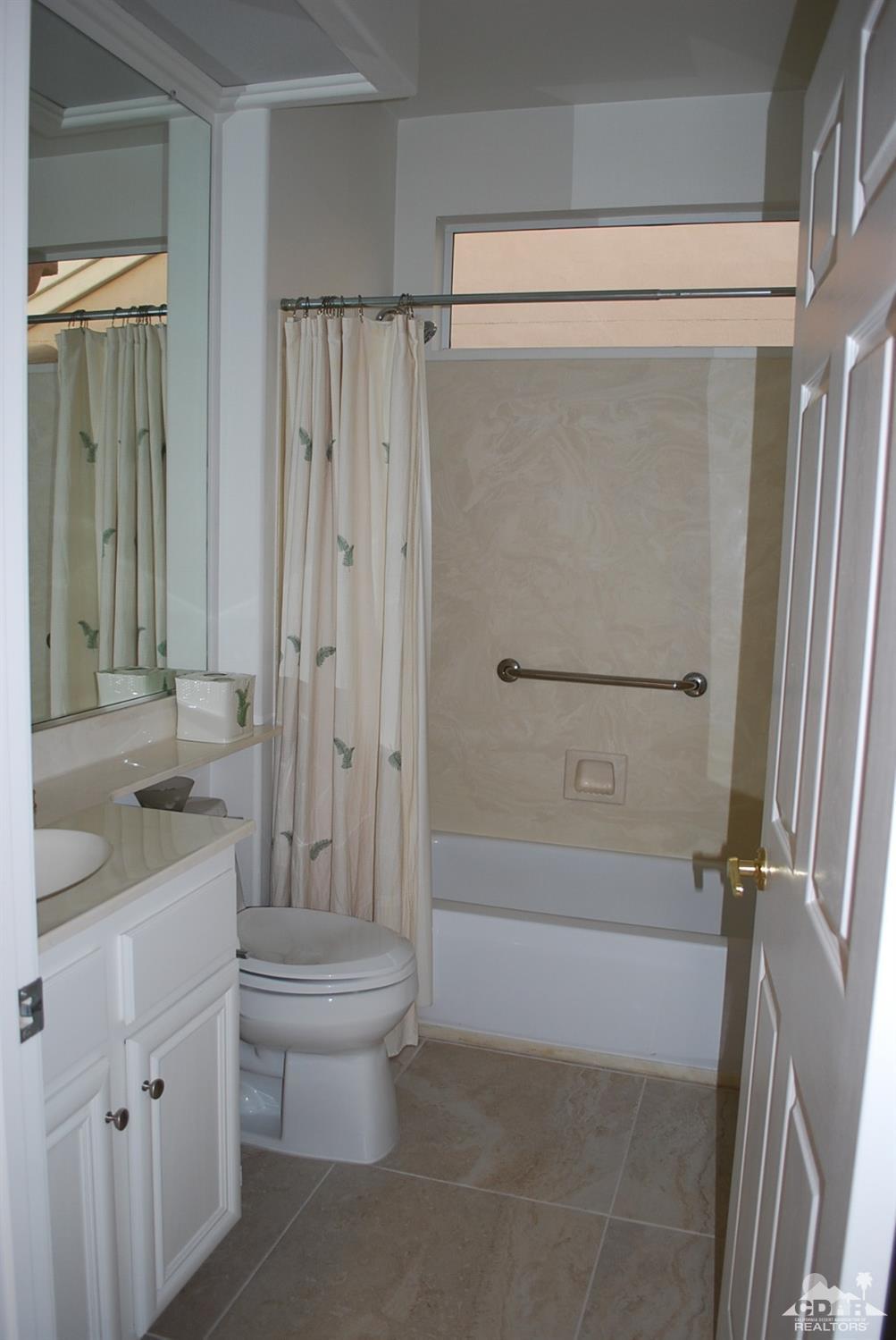 78082 Hunter Point Road Palm Desert, CA 92211 - Photo 28 of 38 a bathroom with a granite countertop shower sink vanity and toilet