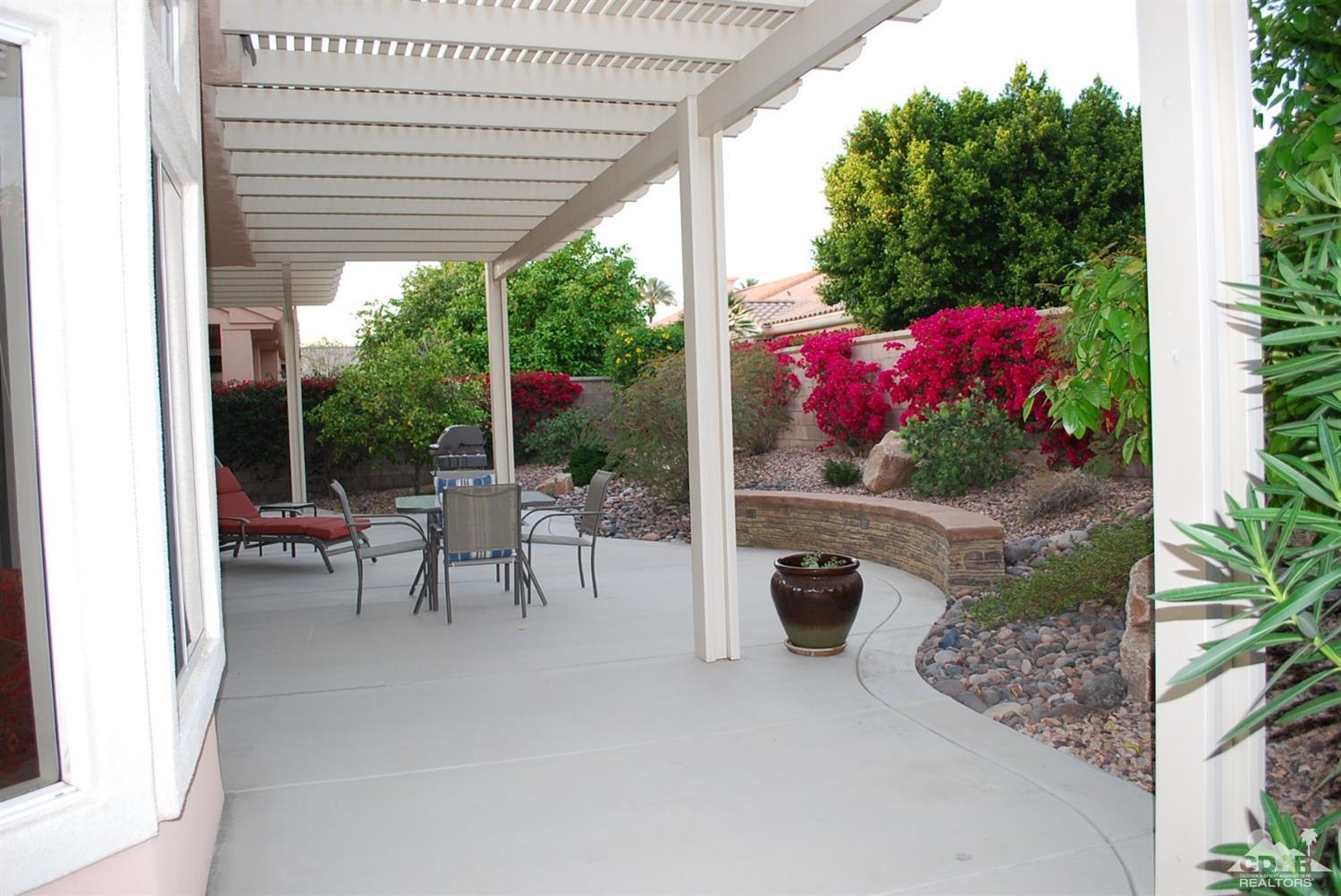 78082 Hunter Point Road Palm Desert, CA 92211 - Photo 32 of 38 a view of patio with a table and chairs and potted plants