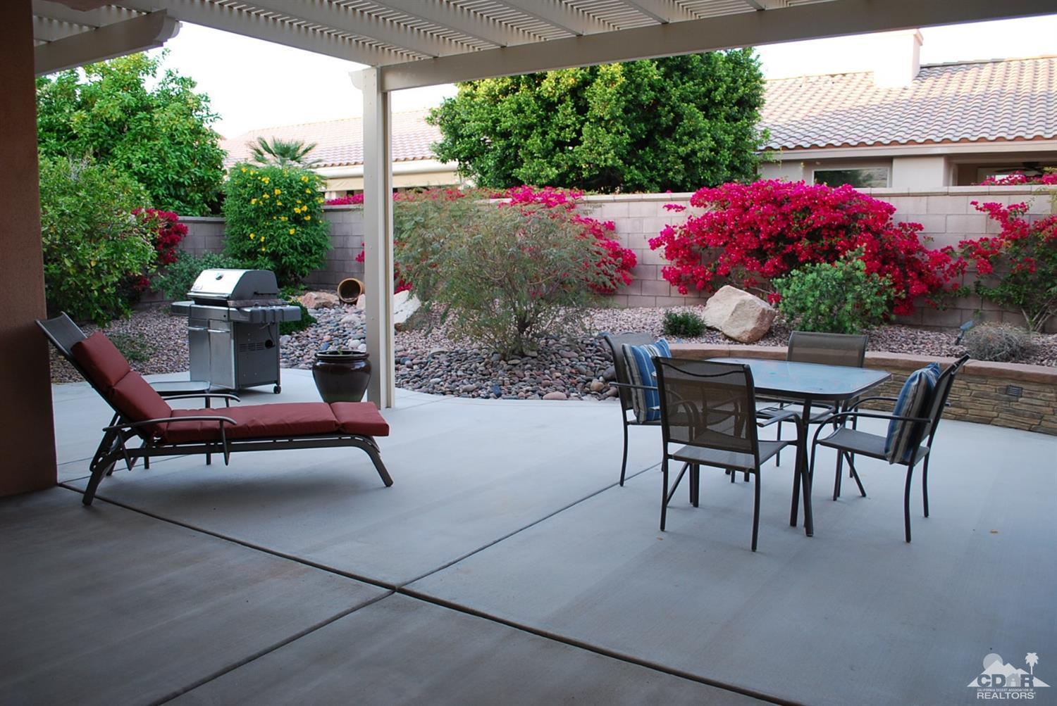 78082 Hunter Point Road Palm Desert, CA 92211 - Photo 33 of 38 a view of a patio with table and chairs and potted plants