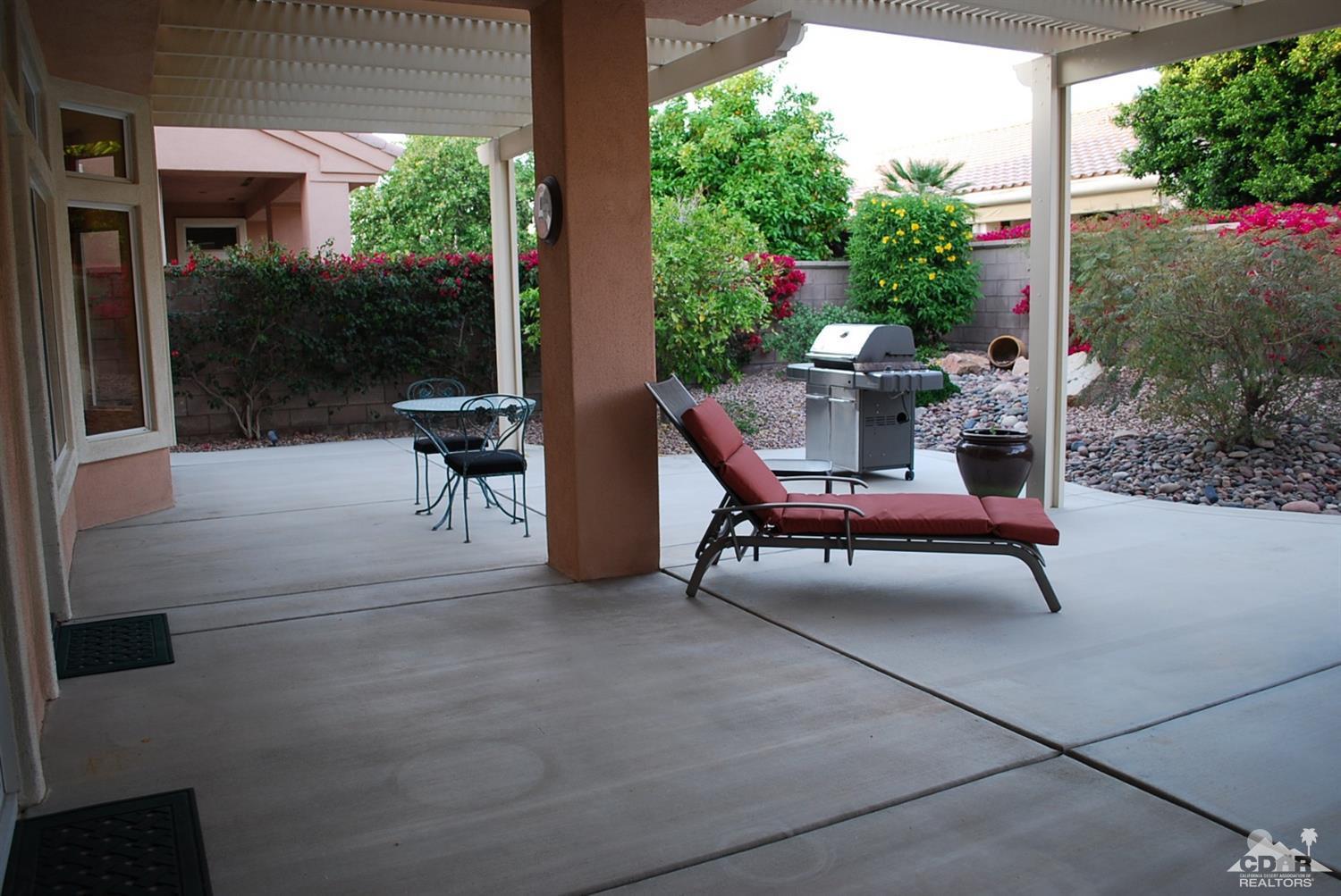 78082 Hunter Point Road Palm Desert, CA 92211 - Photo 34 of 38 a view of a patio with a table and chairs and potted plants