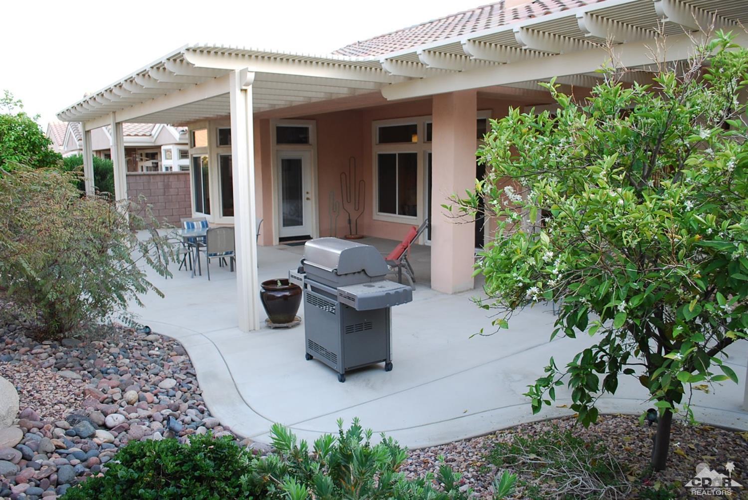 78082 Hunter Point Road Palm Desert, CA 92211 - Photo 35 of 38 a view of a patio with table and chairs and potted plants