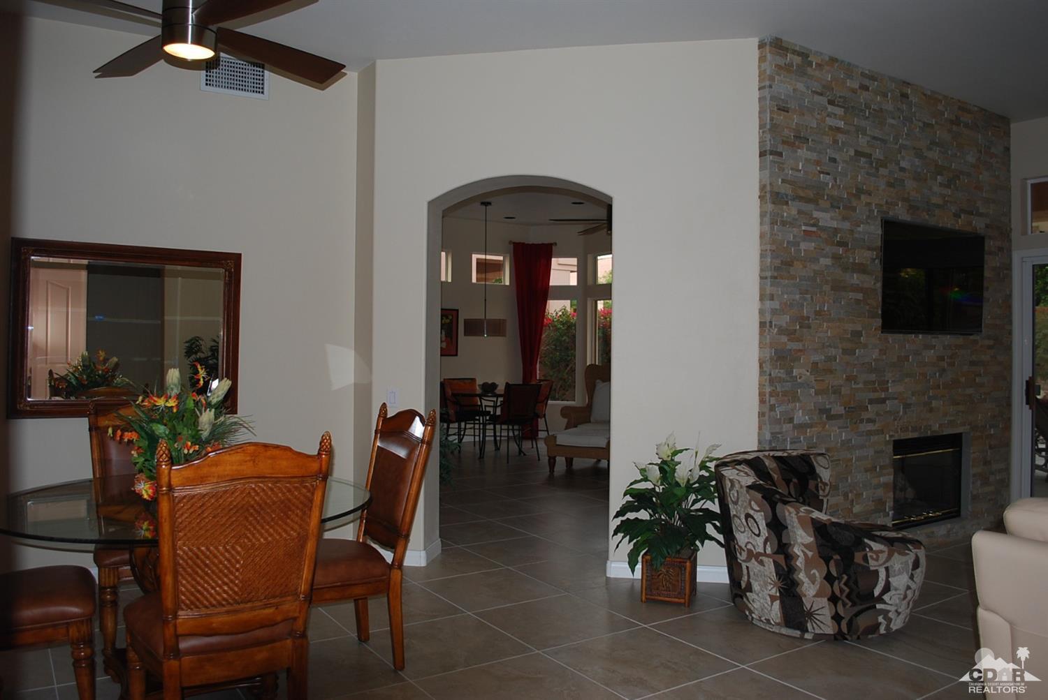 78082 Hunter Point Road Palm Desert, CA 92211 - Photo 7 of 38 a dining room with furniture and chandelier fan