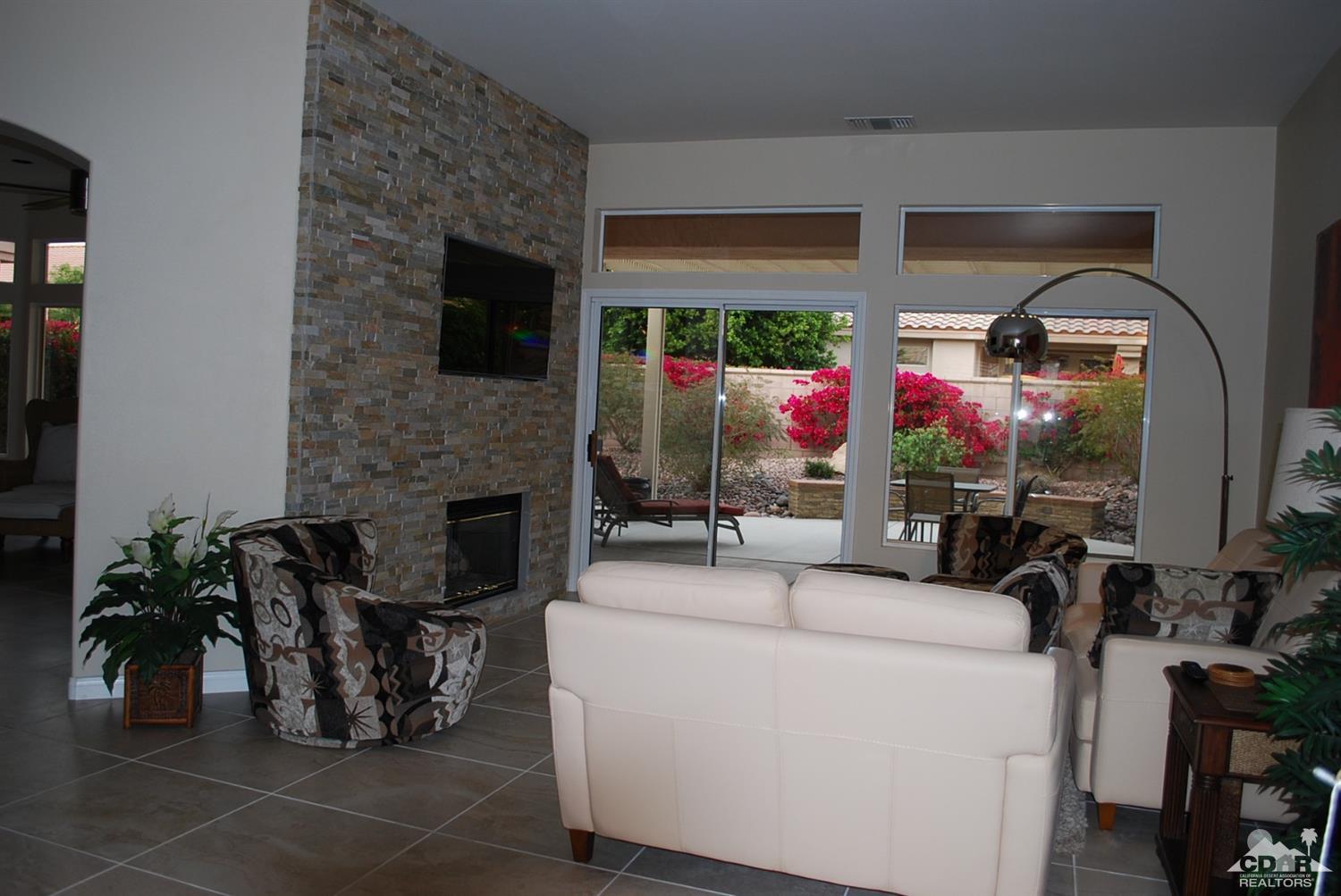 78082 Hunter Point Road Palm Desert, CA 92211 - Photo 8 of 38 a living room with furniture and a fireplace