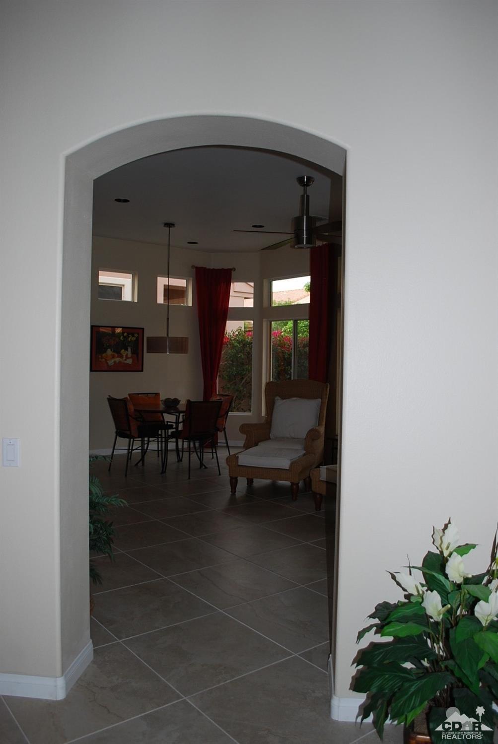 78082 Hunter Point Road Palm Desert, CA 92211 - Photo 9 of 38 a living room with furniture and a potted plant