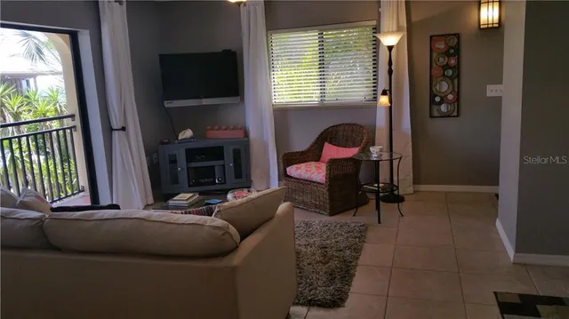 a kitchen with stainless steel appliances granite countertop a refrigerator a sink a stove a dining table and chairs