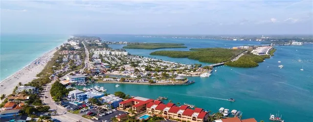 a view of a lake with houses in back