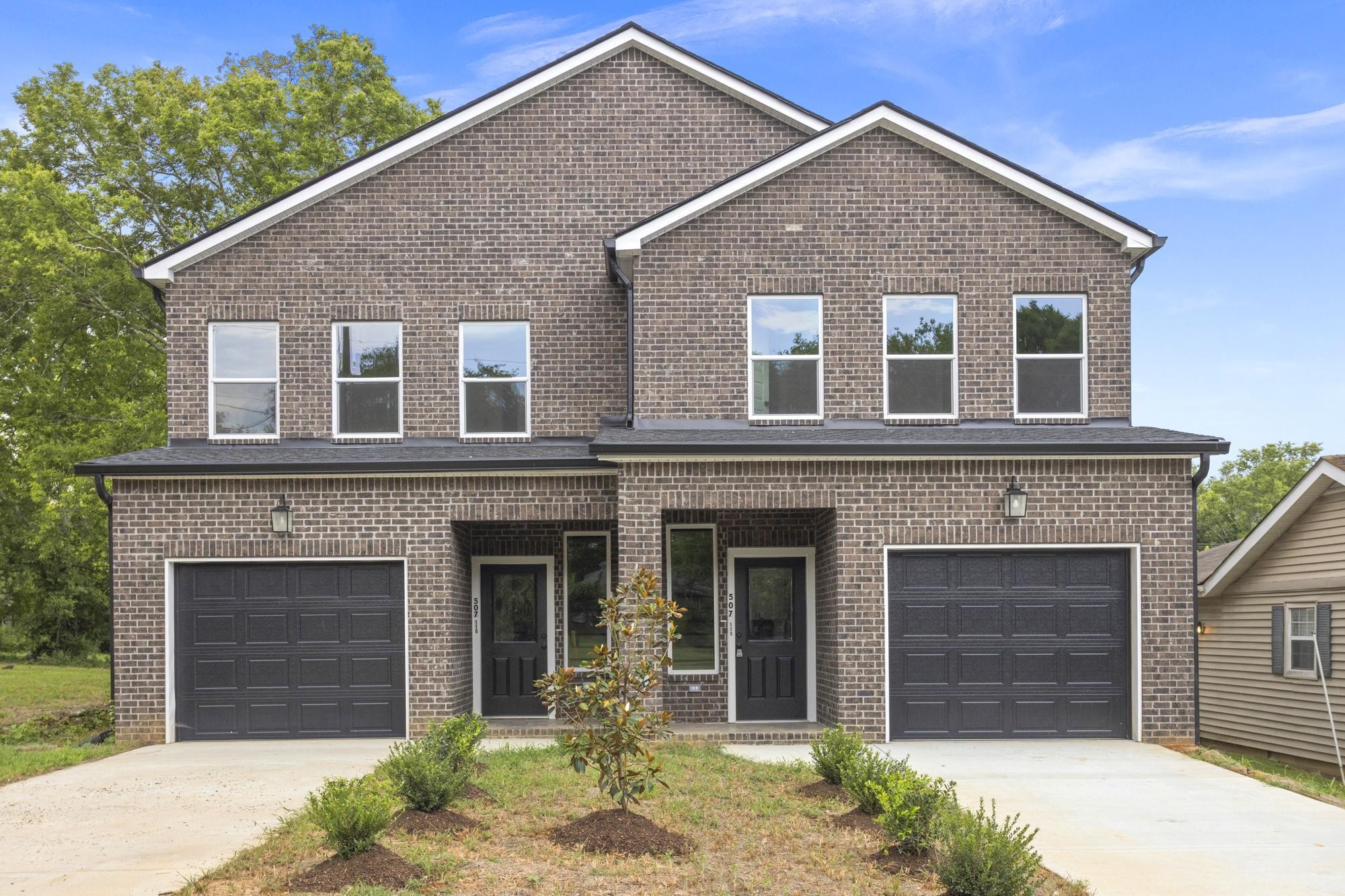 a front view of a house with a yard and garage