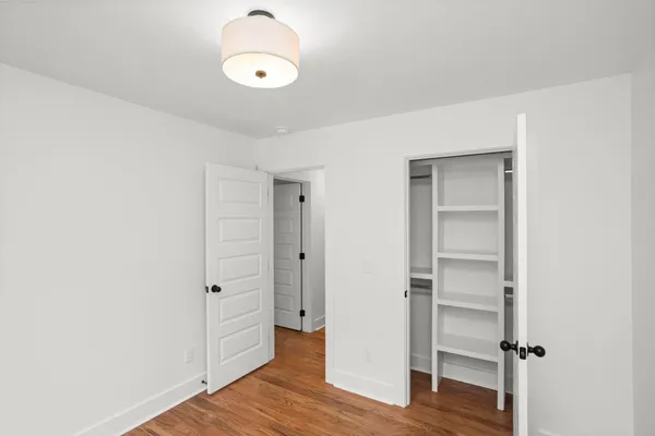 a view of a room with wooden floor