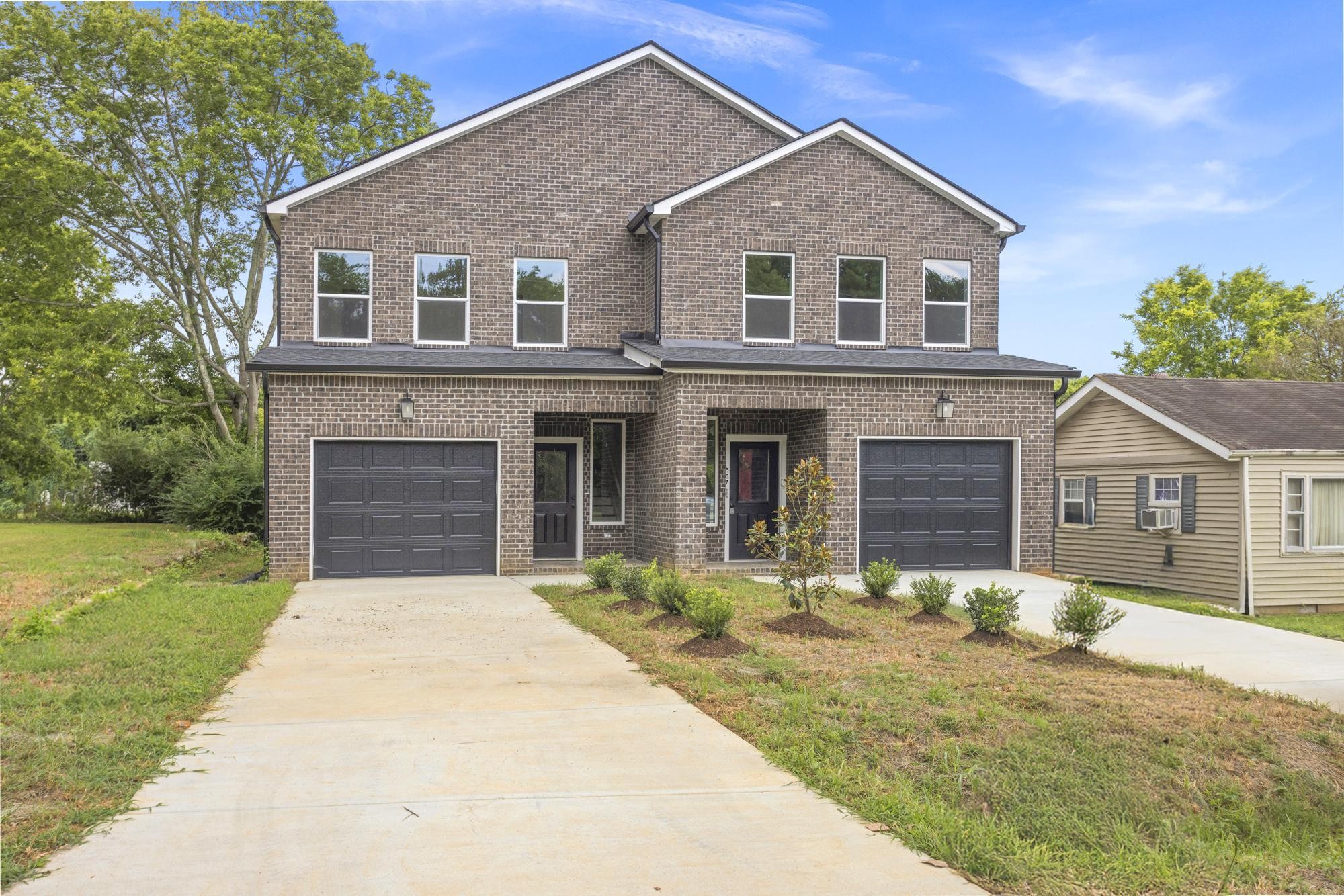 507 Demoss Street, Unit 110 Gallatin, TN 37066 - Photo 2 of 27 a front view of a house with garden