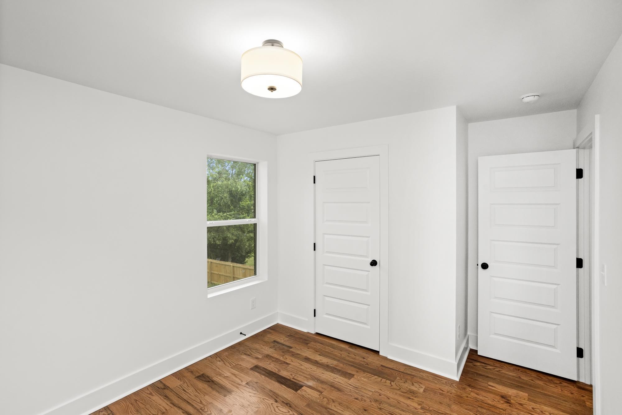 507 Demoss Street, Unit 110 Gallatin, TN 37066 - Photo 22 of 27 an empty room with wooden floor and windows