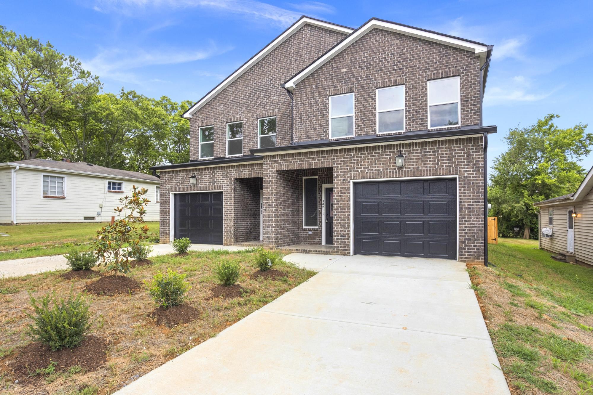 507 Demoss Street, Unit 110 Gallatin, TN 37066 - Photo 3 of 27 a front view of a house with a yard and garage
