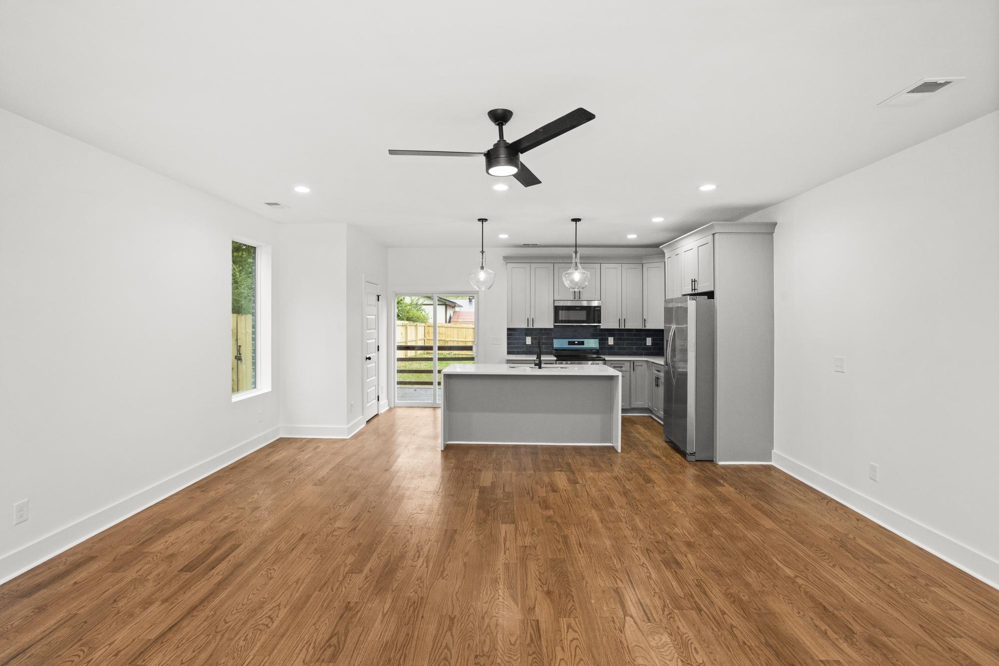 507 Demoss Street, Unit 110 Gallatin, TN 37066 - Photo 7 of 27 a large kitchen with cabinets wooden floor and stainless steel appliances