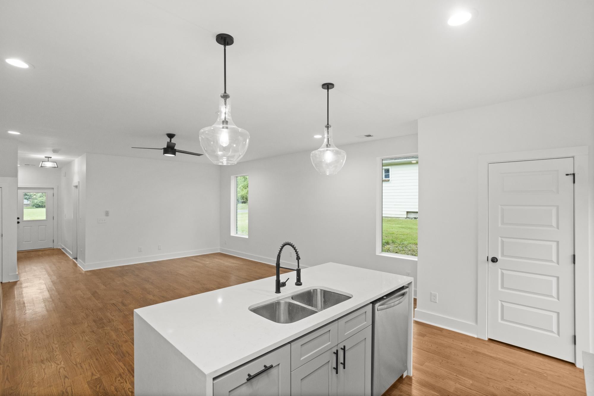 507 Demoss Street, Unit 110 Gallatin, TN 37066 - Photo 8 of 27 a kitchen with kitchen island a sink stainless steel appliances and wooden floor