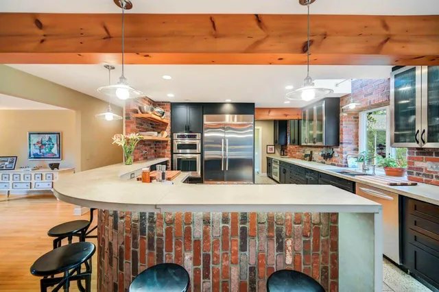a dining room with furniture a fireplace and wooden floor