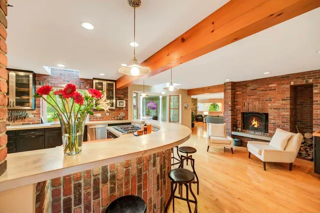 a living room with furniture a dining table and chairs with wooden floor