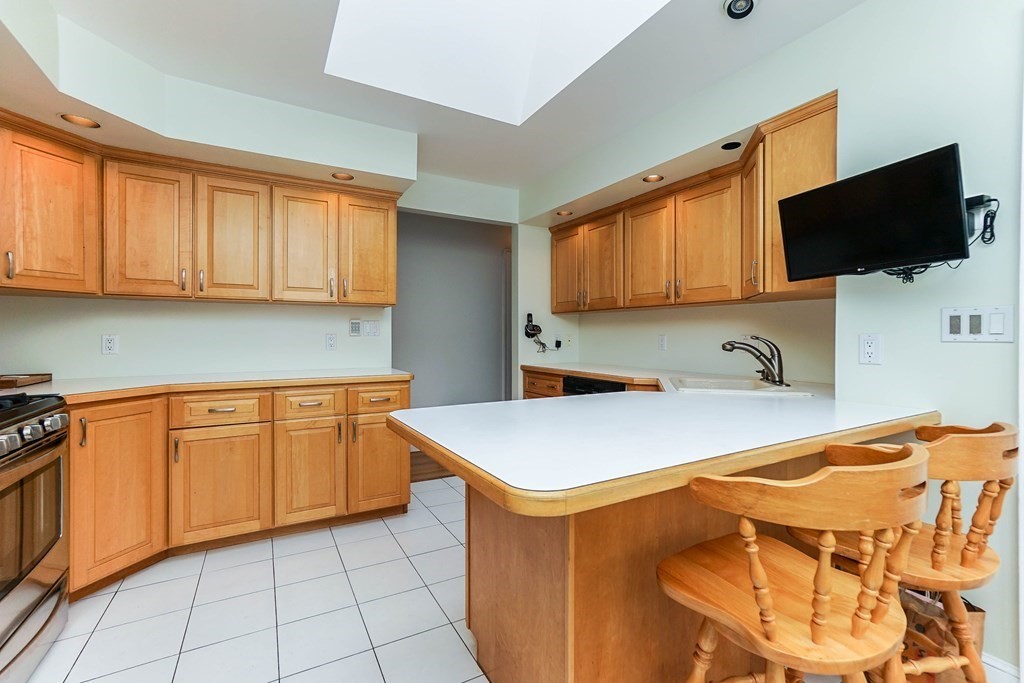 7 Dana Road Newton, MA 02465 - Photo 8 of 26 a kitchen with stainless steel appliances a stove a sink and a microwave