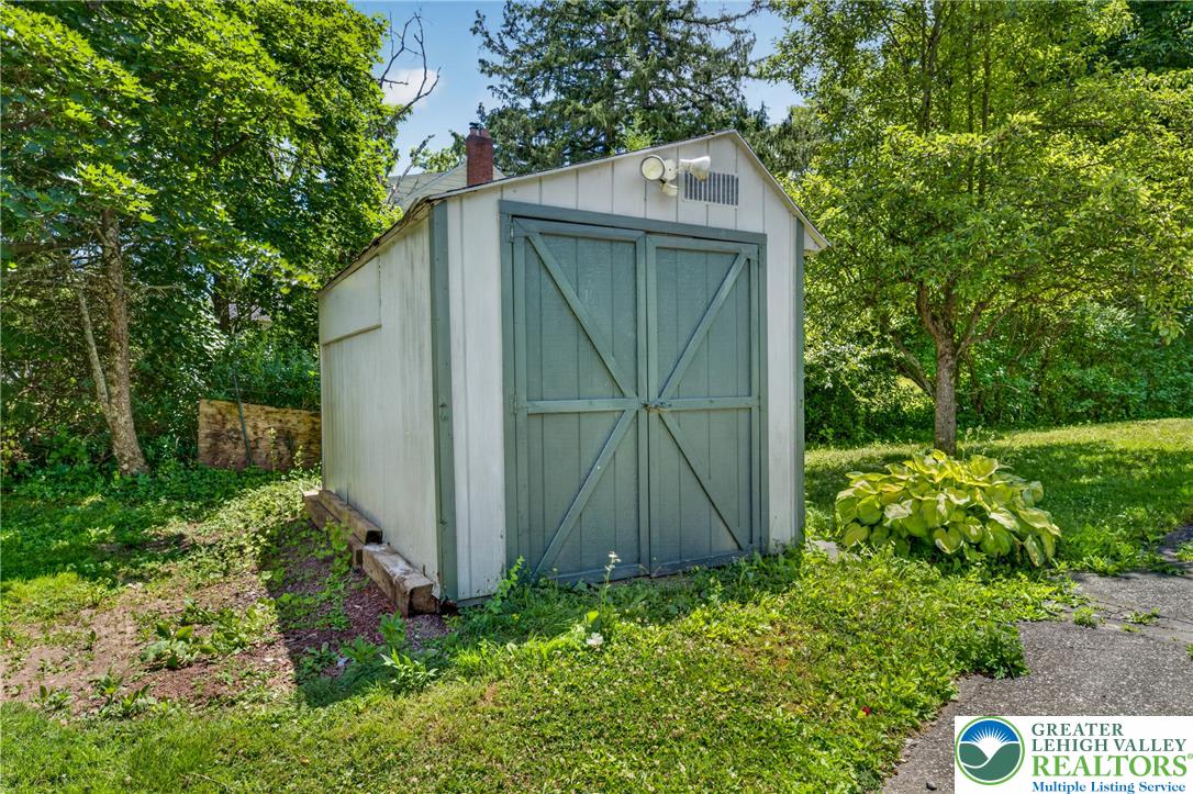 2674 Williams Road Danielsville, PA 18038 - Photo 8 of 31 A quaint storage shed offers functional utility within a verdant setting.