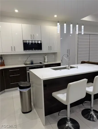 a kitchen with a sink cabinets and stainless steel appliances