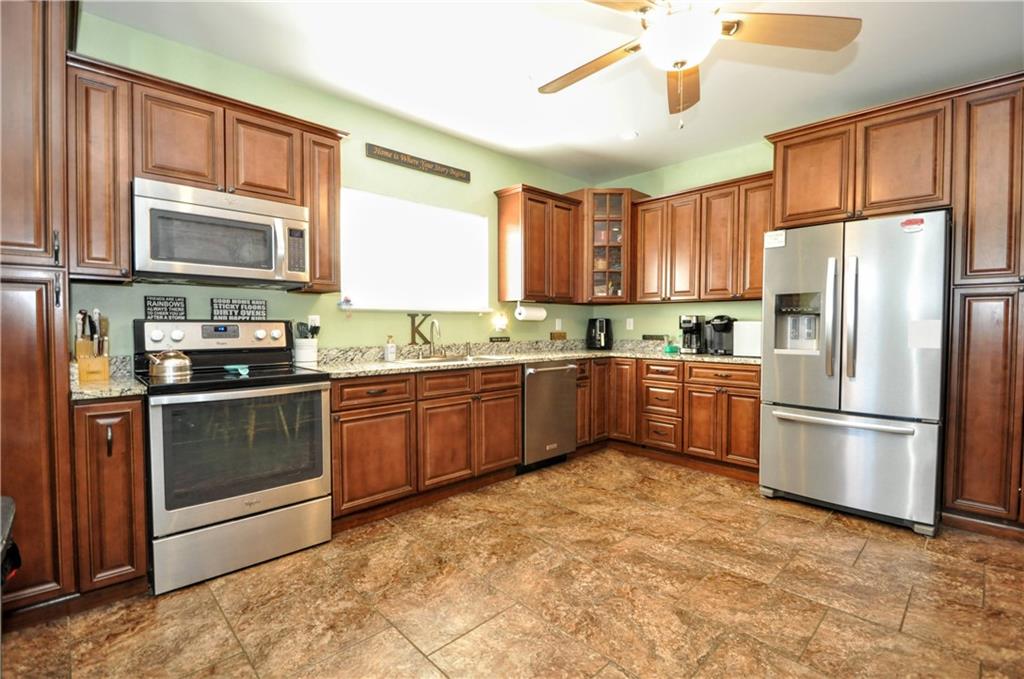 104 Navy Street Perryopolis, PA 15473 - Photo 8 of 45 a kitchen with a refrigerator a sink and cabinets