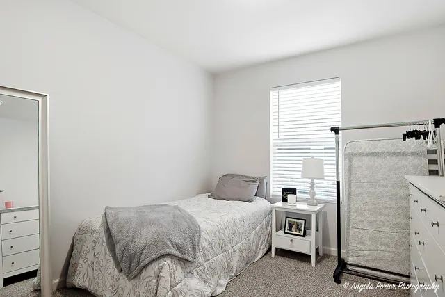 a bedroom with a bed and a dresser