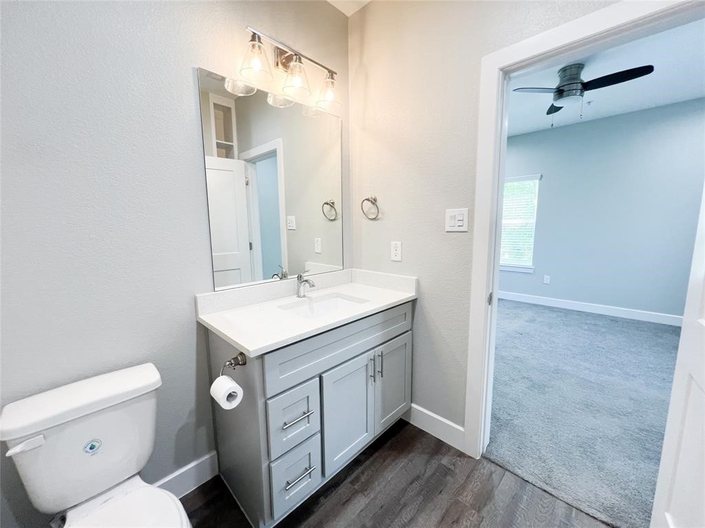 144 West 5th Street, Unit B Kemah, TX 77565 - Photo 14 of 22 a bathroom with a sink toilet vanity and a mirror