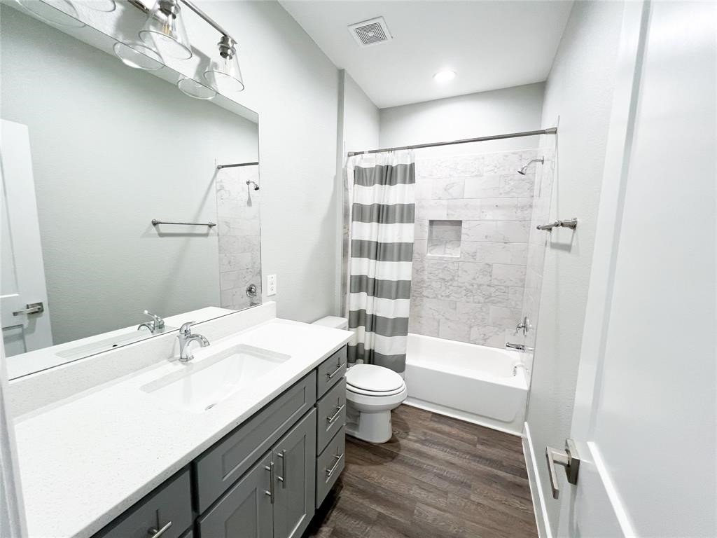 144 West 5th Street, Unit B Kemah, TX 77565 - Photo 19 of 22 a bathroom with a bathtub shower sink mirror and toilet