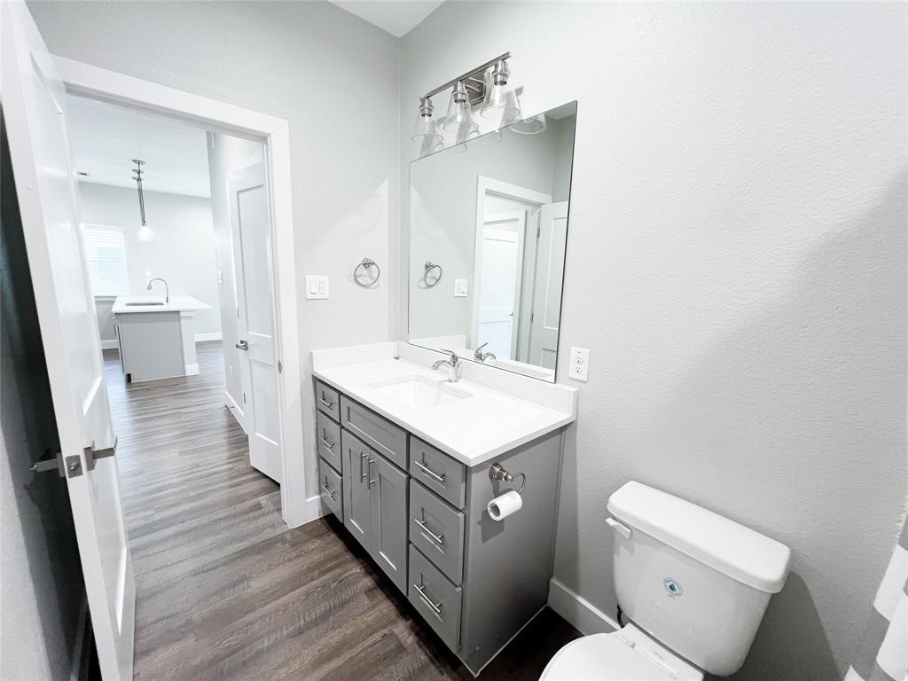 144 West 5th Street, Unit B Kemah, TX 77565 - Photo 20 of 22 a bathroom with a sink a toilet and a mirror