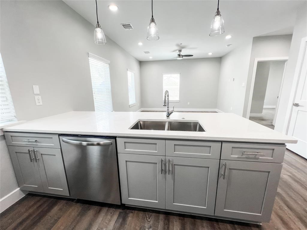 144 West 5th Street, Unit B Kemah, TX 77565 - Photo 4 of 22 a kitchen with a sink and wooden floor
