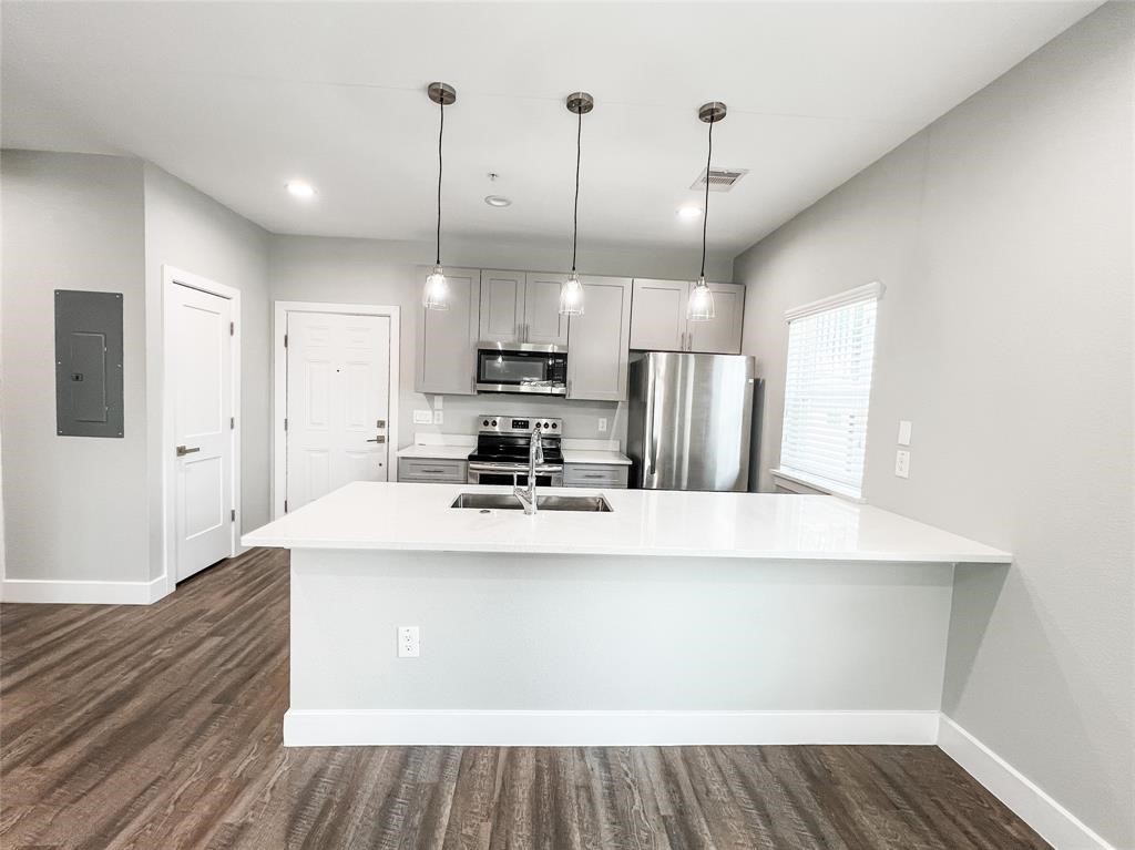 144 West 5th Street, Unit B Kemah, TX 77565 - Photo 7 of 22 a kitchen with stainless steel appliances a refrigerator sink and microwave